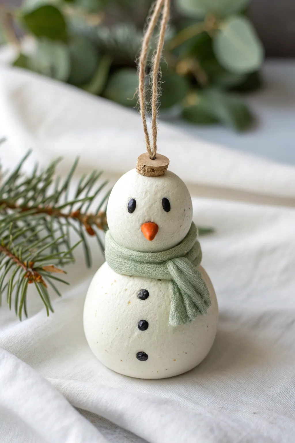 Classic clay snowman ornament with cozy scarf detail, minimalist winter charm for your tree.