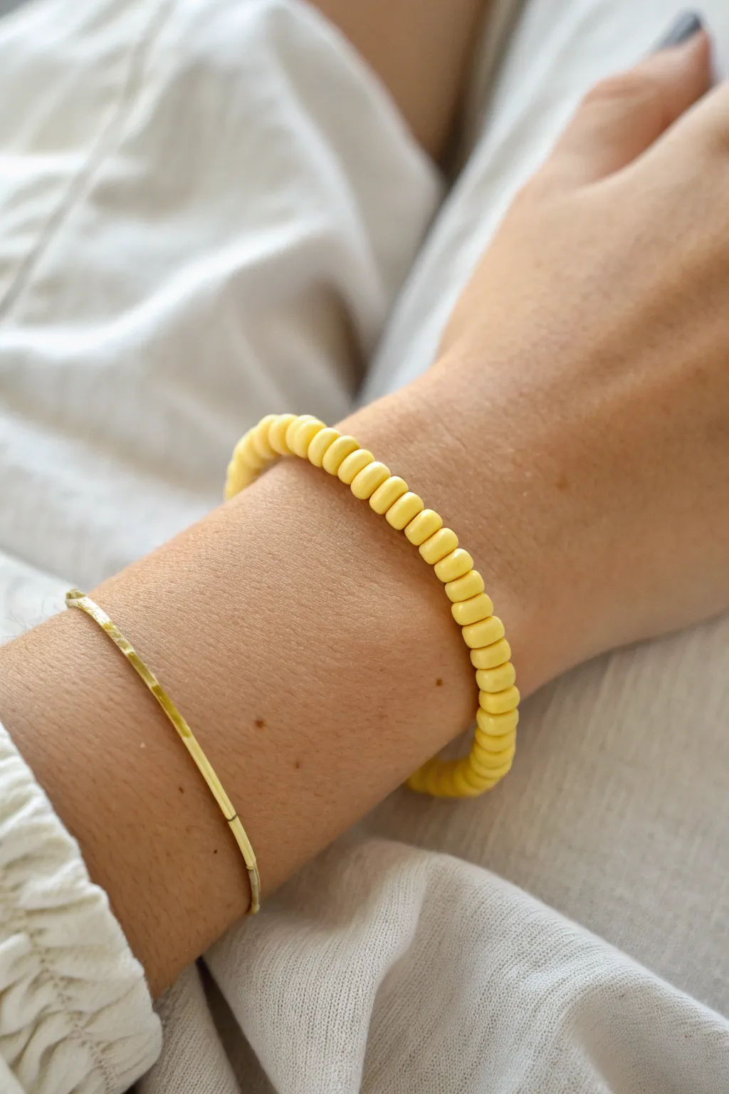 Classic all-yellow heishi bracelet in warm natural light, minimal and handmade-friendly