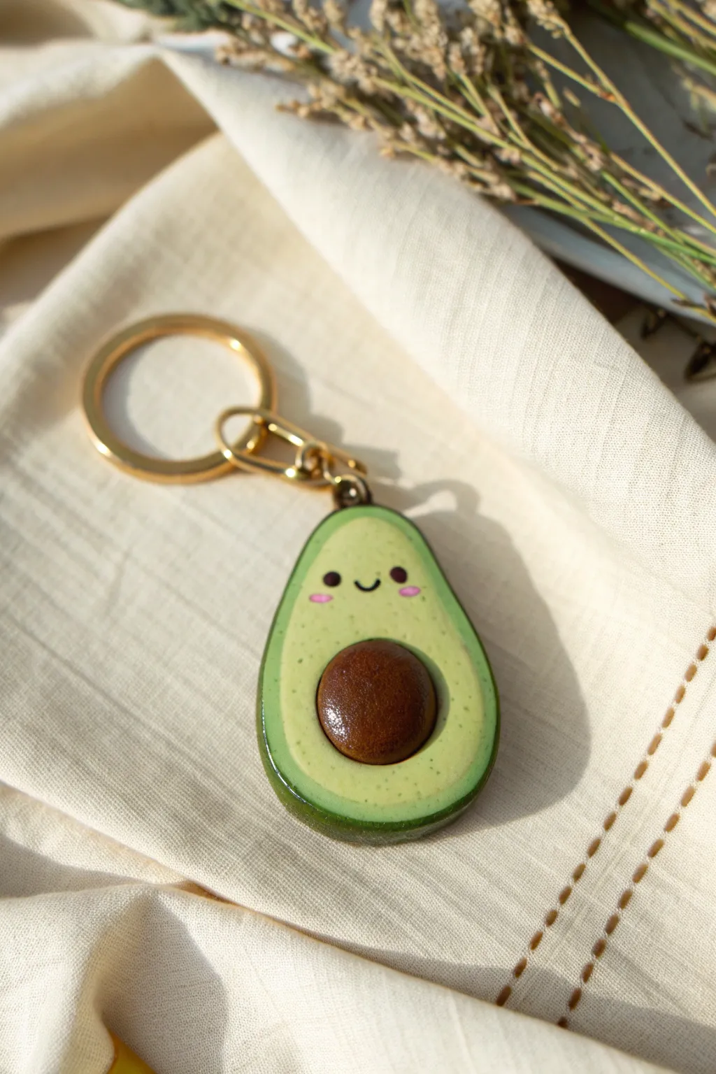 Sweet avocado half clay keychain charm in two greens with glossy finish and cute face