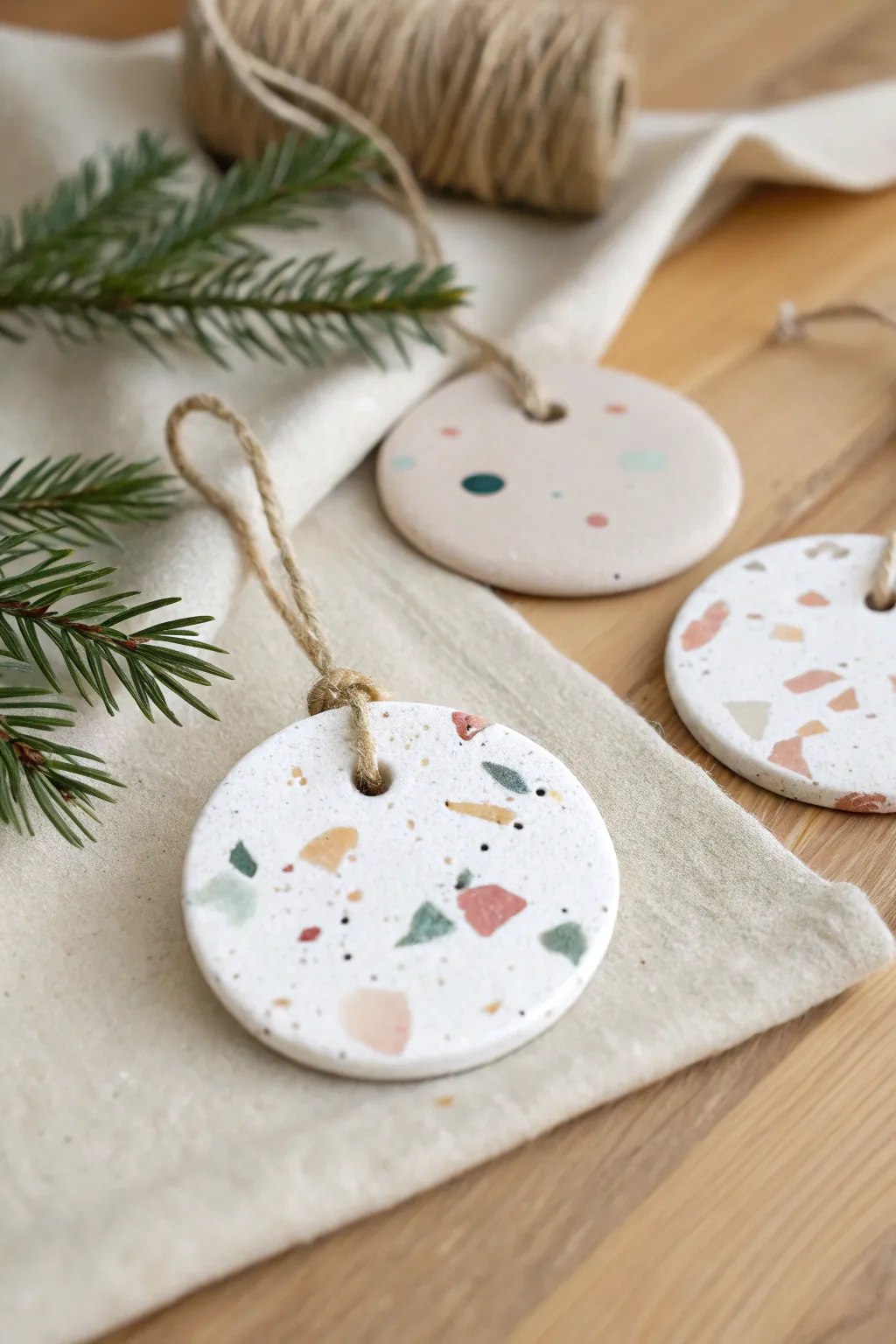 Terrazzo speckle confetti air dry clay ornaments in soft muted tones for a modern cozy tree.