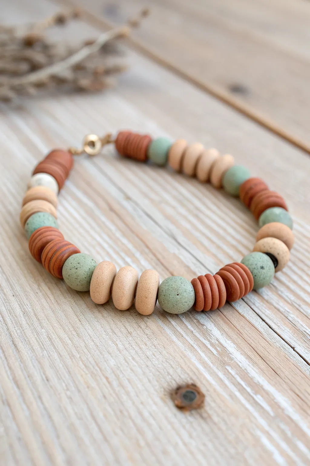 Earthy wood-and-clay bracelet layering in muted tones, sunlit on oak for minimalist boho calm
