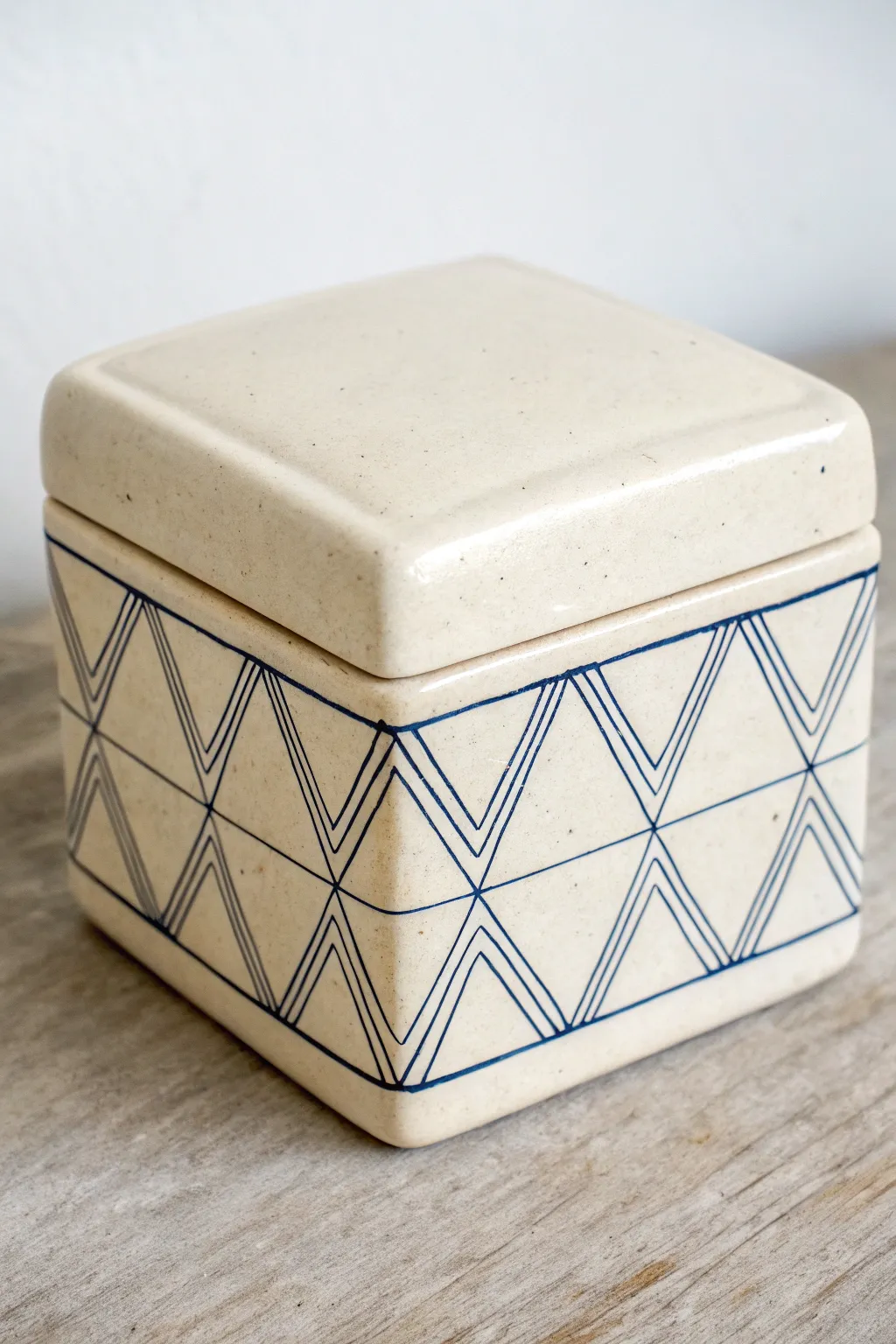 Minimal lidded ceramic box with carved inlay lines and indigo underglaze for bold contrast