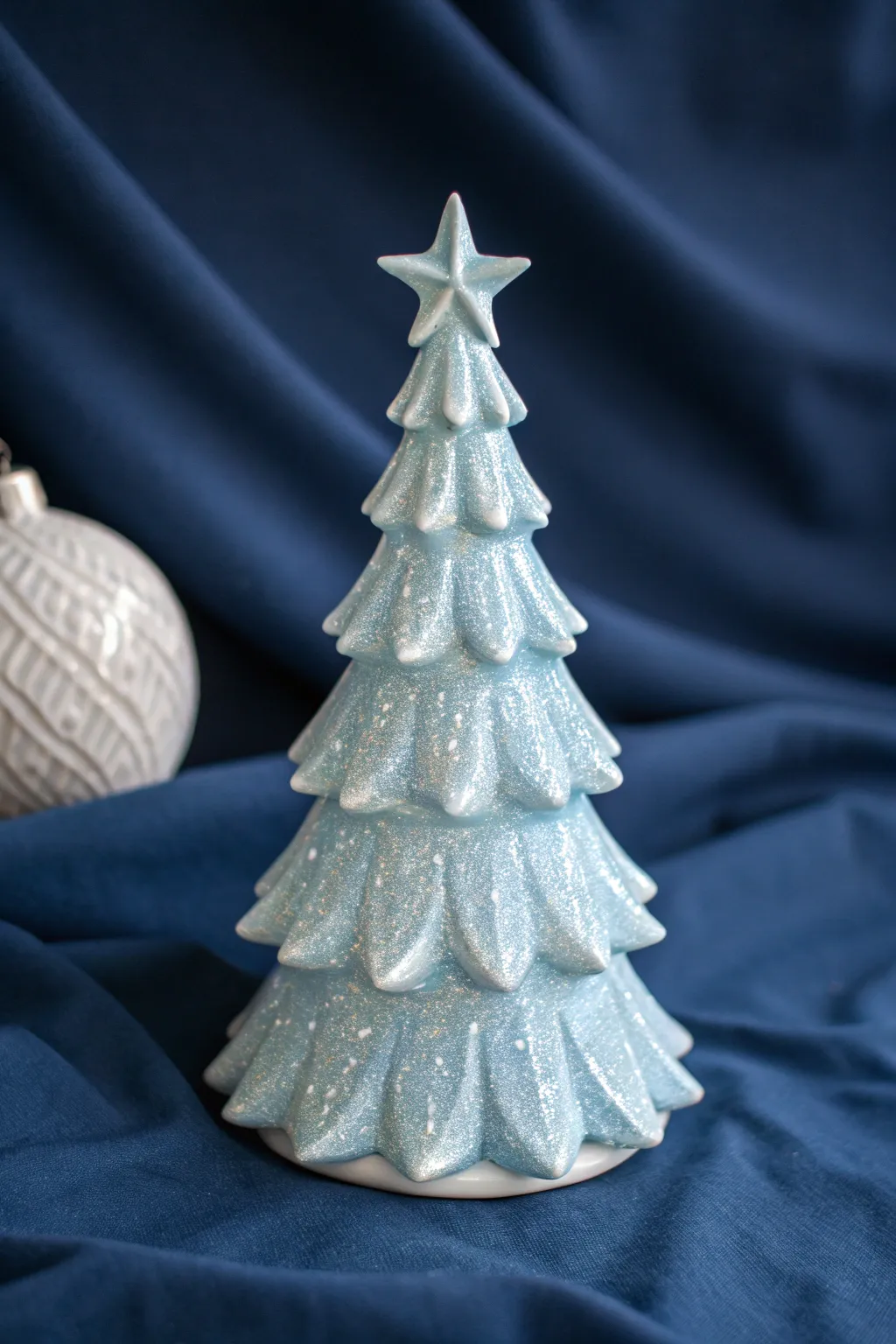 Icy blue ceramic tree with a glitter topcoat that shimmers like fresh frost in soft light.