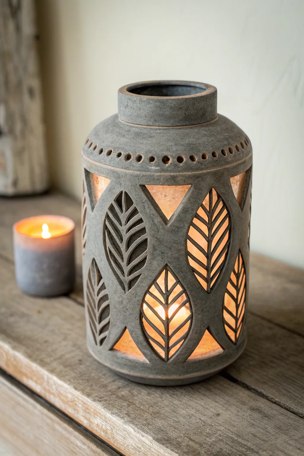 Bold sgraffito ceramic lantern with warm inner glow and striking clay contrast for cozy minimal decor