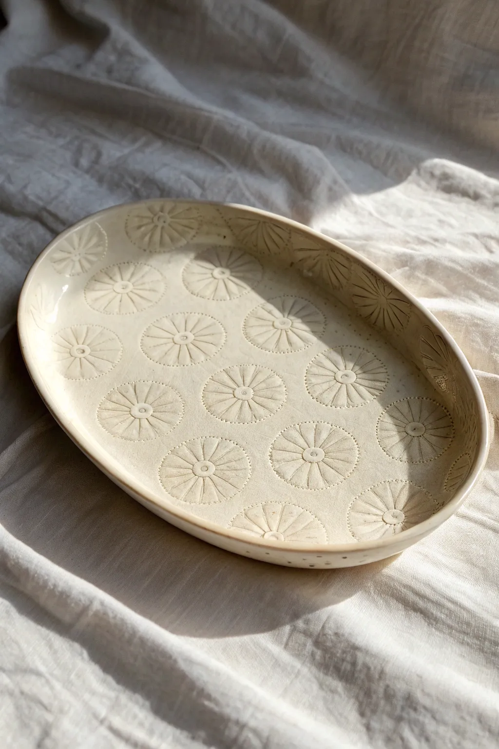 Stamped floral texture meets soft pooled glaze for a simple, elegant ceramic platter idea