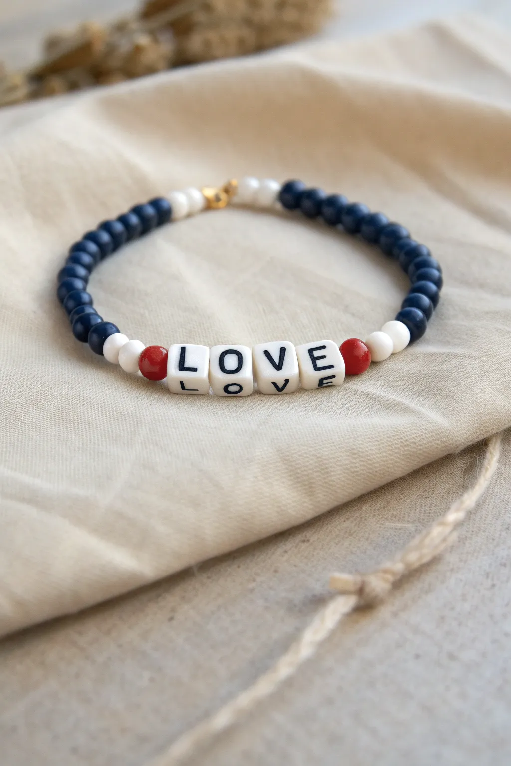 Navy and white clay beads with a tiny red pop make the letter beads stand out beautifully.