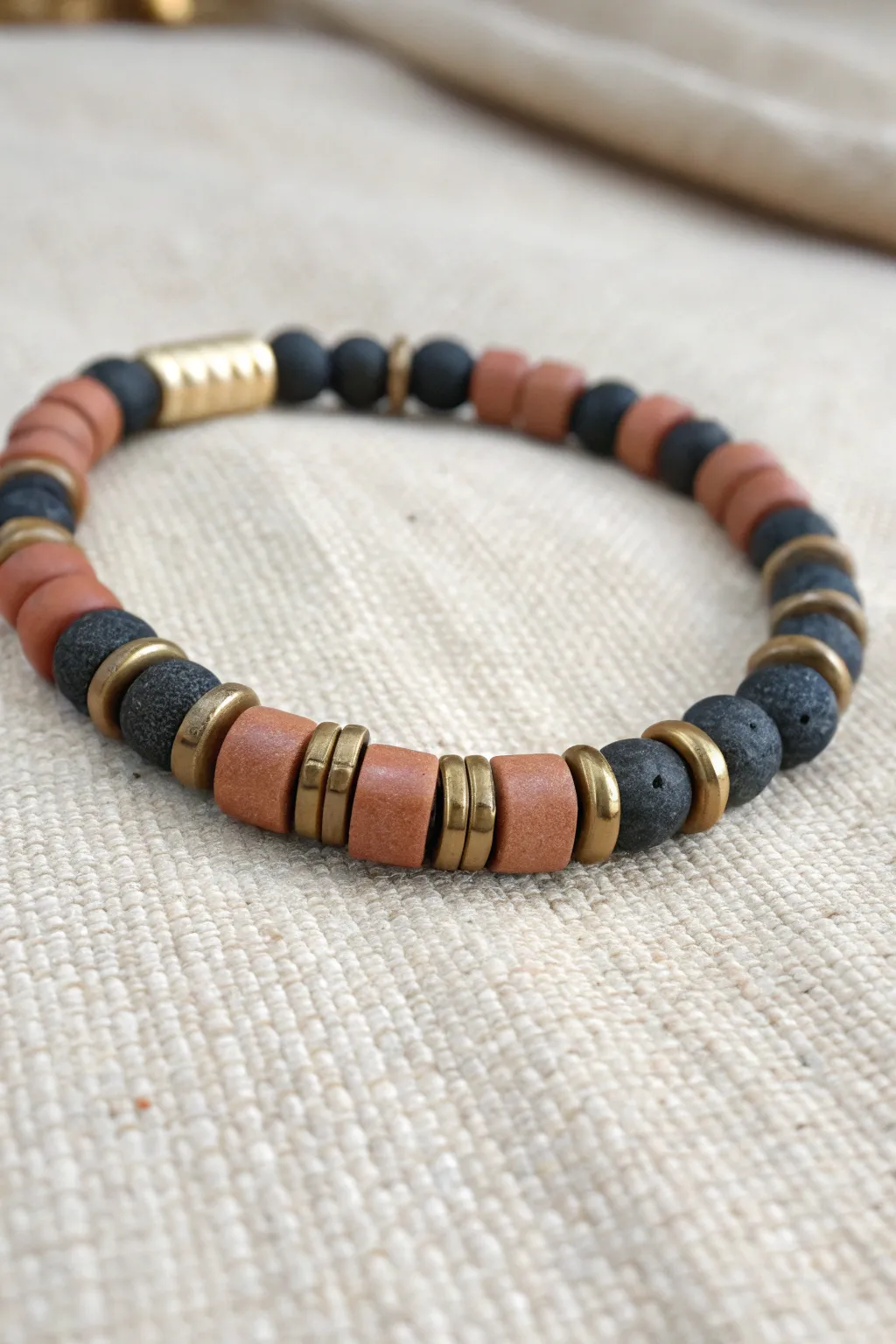 Segmented clay bead bracelet with tube spacers for a clean, cuff-like look guys will wear.
