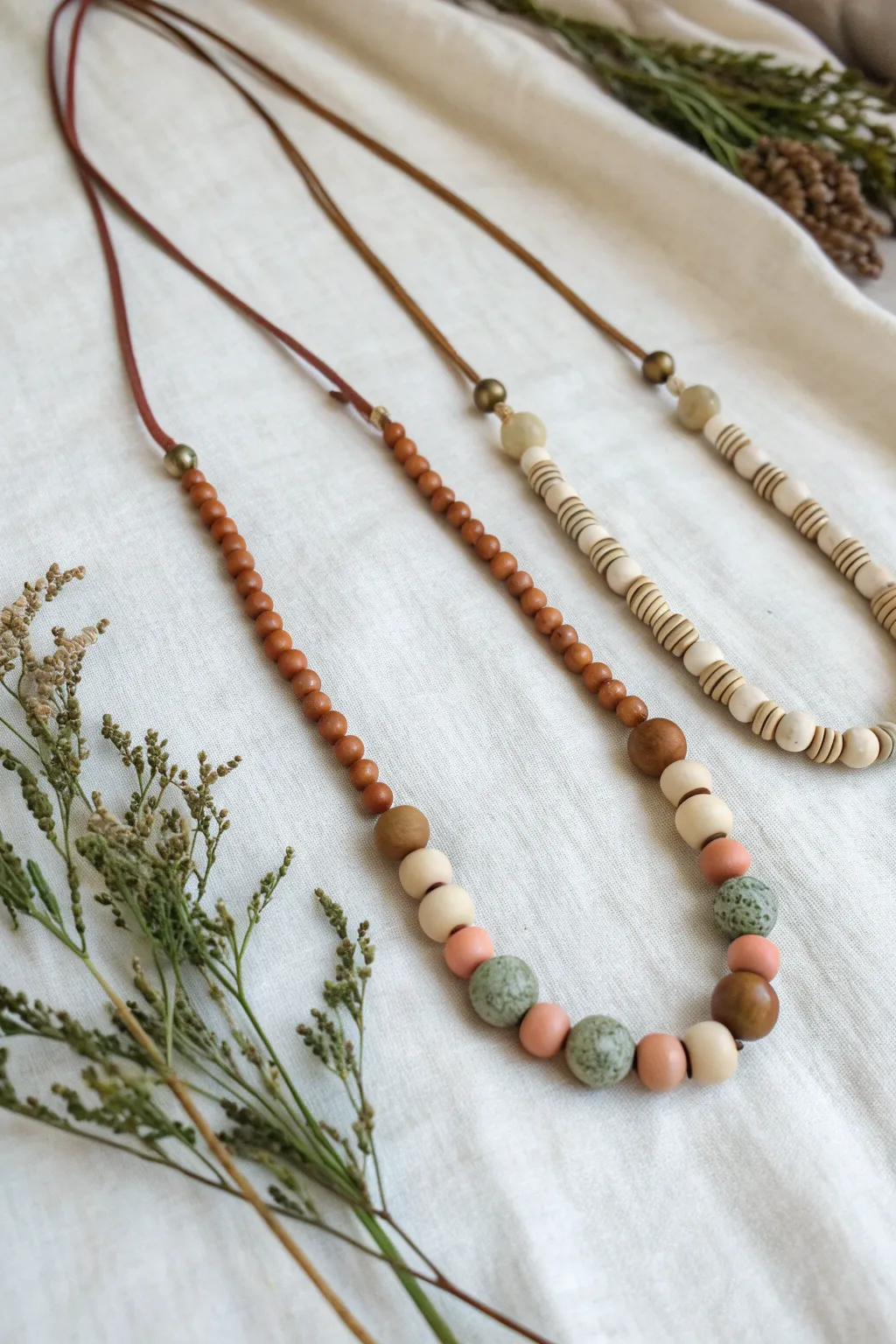 Neck stack inspo: three coordinated handmade clay bead necklaces for easy layered styling.