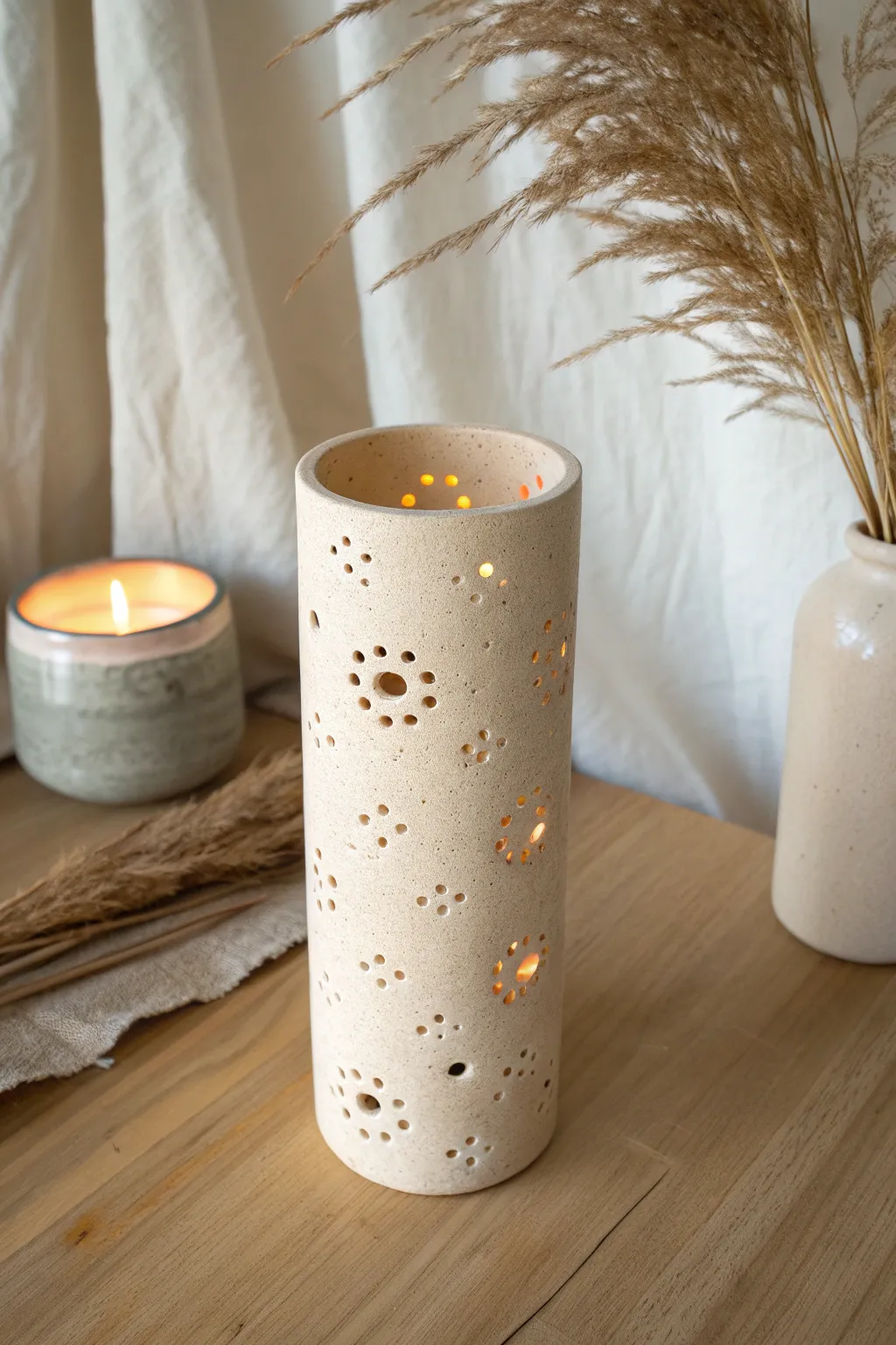 Simple cutout clay lantern votive casting soft dotted light for a cozy minimalist glow