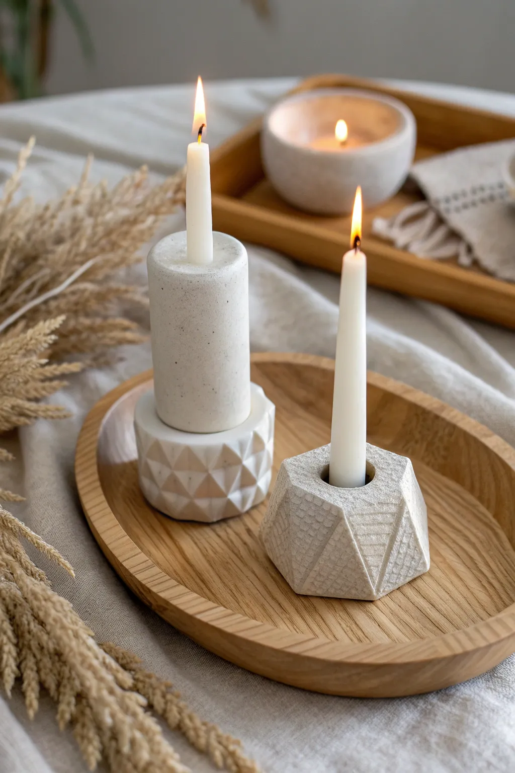 Simple sculpted clay candle holders, wavy and geometric, glowing in a cozy minimalist nook.