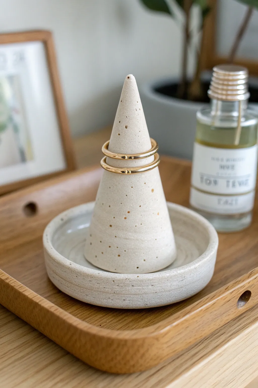 Minimal speckled clay ring cone on a wooden tray with soft light and simple boho warmth