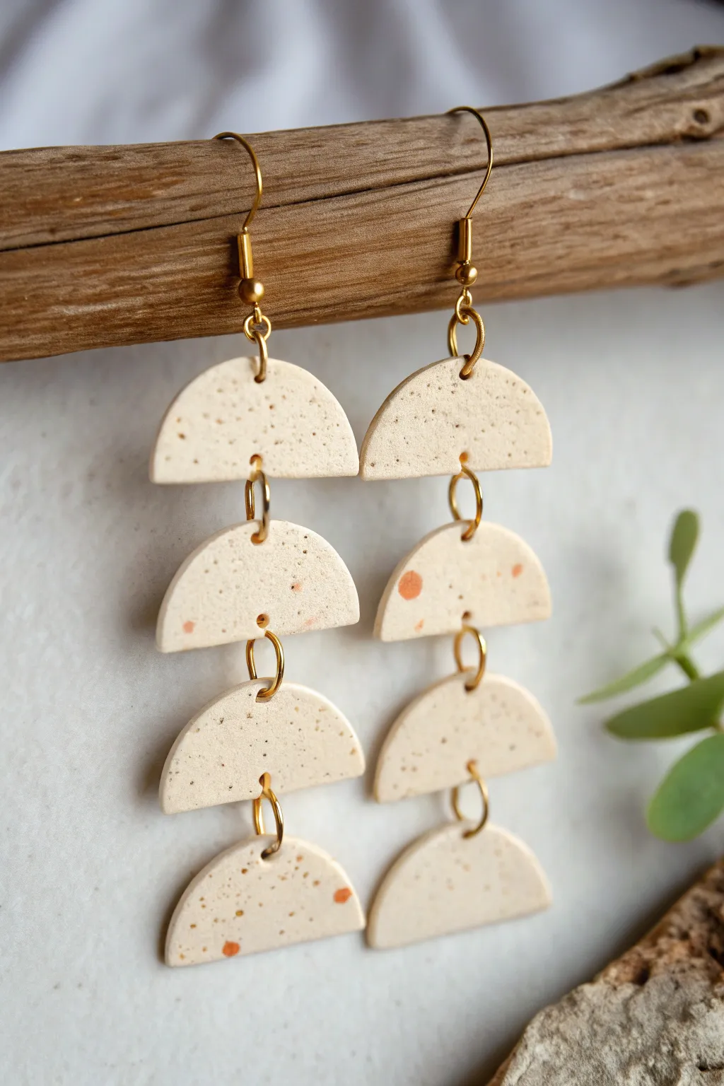 Multi-tiered clay dangle earrings with linked shapes, minimalist boho style and clean contrast