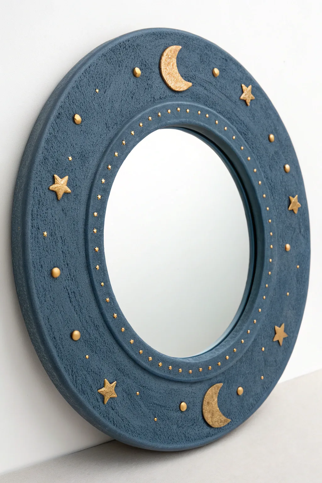 Celestial clay mirror with moon and tiny planets in deep blue and soft gold tones