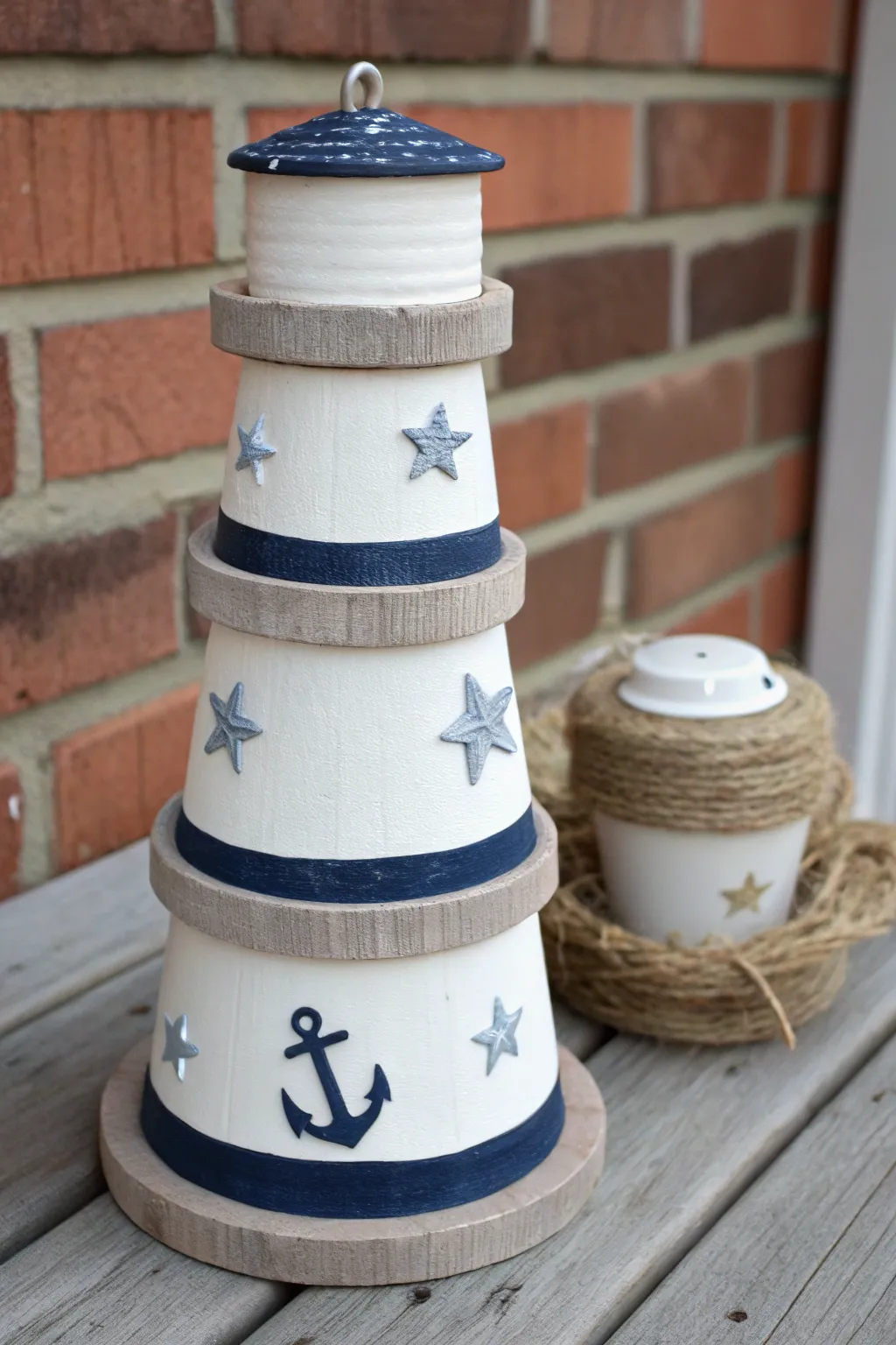 Minimal clay pot lighthouse with simple anchor, stars, and life-ring accents for coastal charm