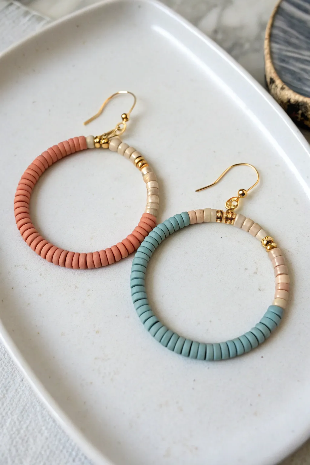 Mismatched warm and cool heishi hoops that still feel perfectly coordinated and handmade