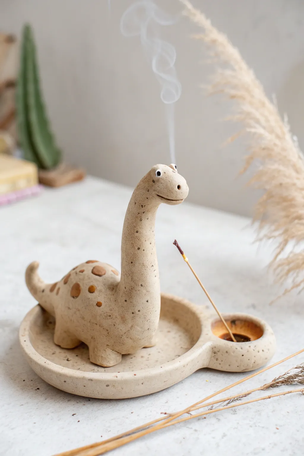 Minimal clay dinosaur incense holder with a curled tail tray, calm Scandinavian boho decor