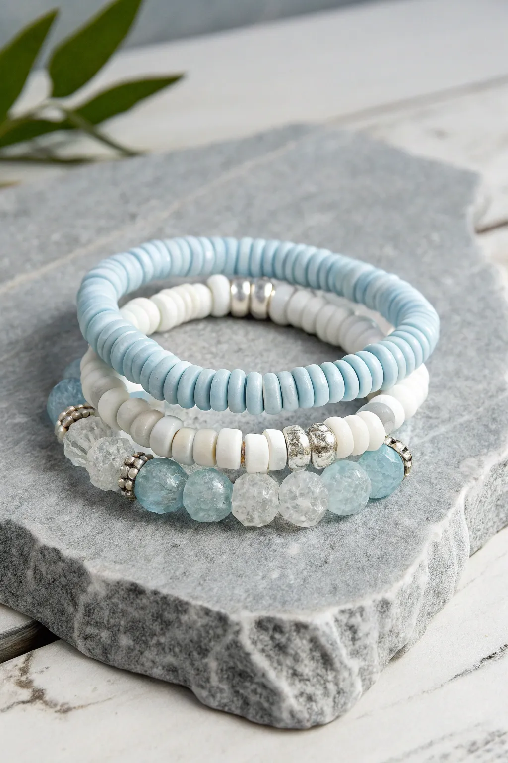 Frozen-inspired icy blue and white heishi stack with glitter spacers, minimalist winter sparkle.