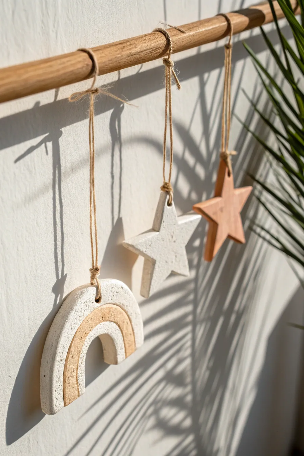 Simple ceramic ornaments in soft neutrals, tied with linen string for a calm boho touch.