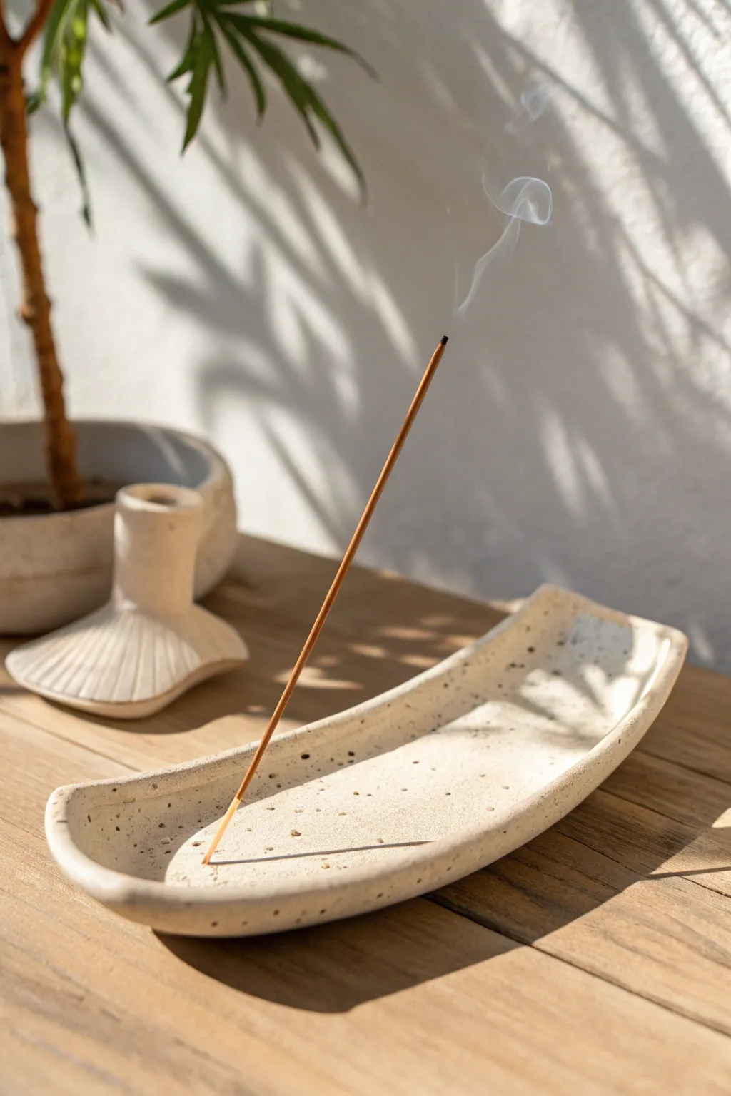 Minimal curved clay incense holder with easy groove lines, calm Nordic style and soft contrast