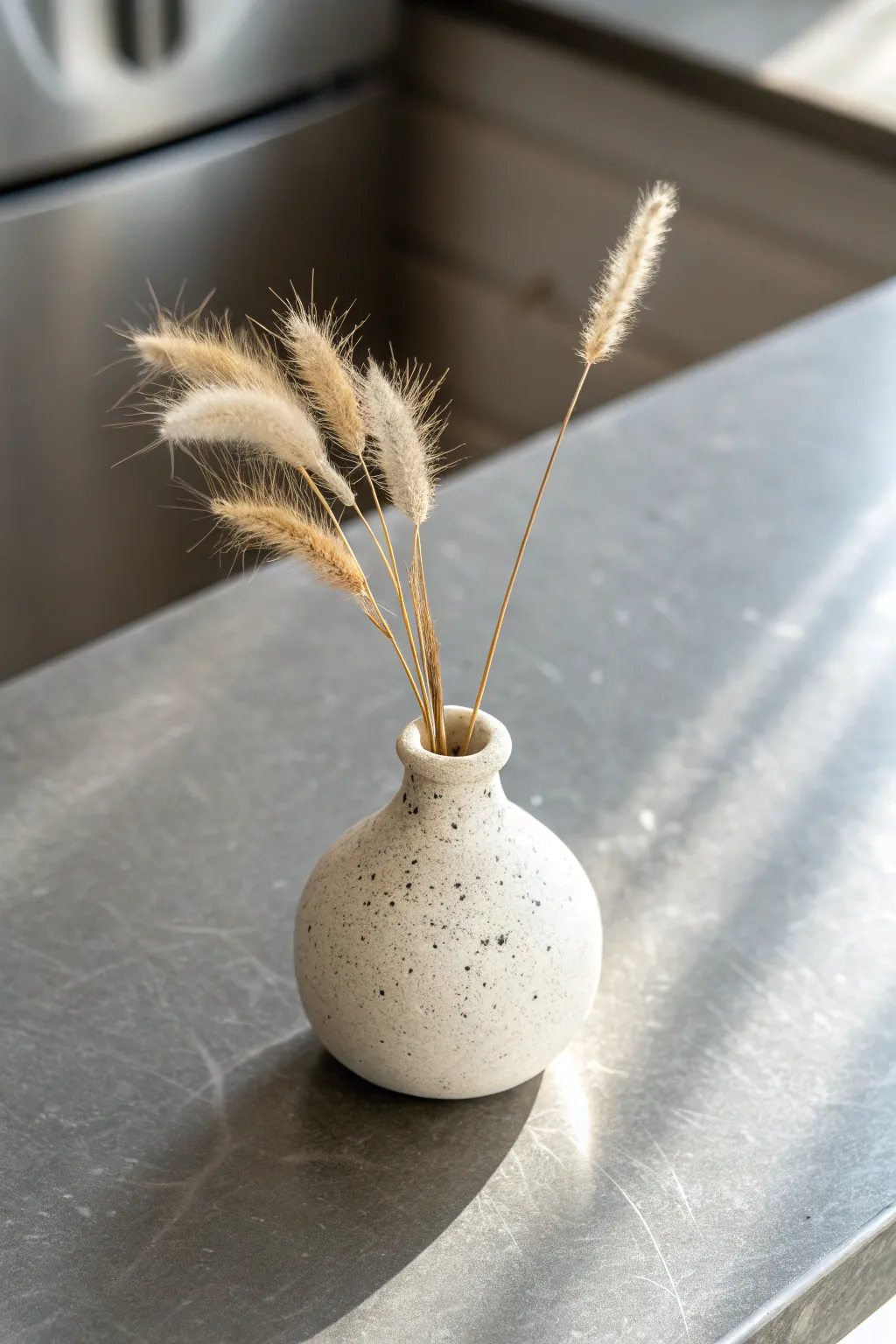Tiny clay bud vase magnet with a single dried stem, minimalist Scandinavian charm for any fridge