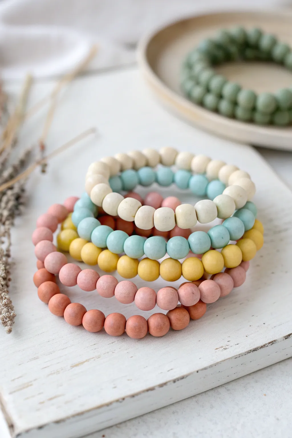 Playful air dry clay beaded bracelets and bangles in soft pastels on a clean white backdrop