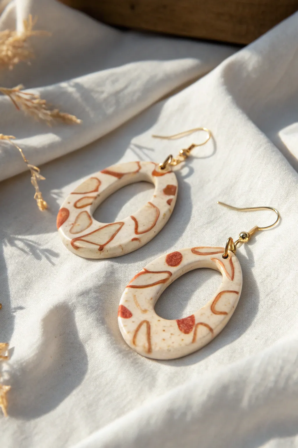 Bold scribble loop earrings from liquid clay drizzles, minimalist boho charm in soft contrast.