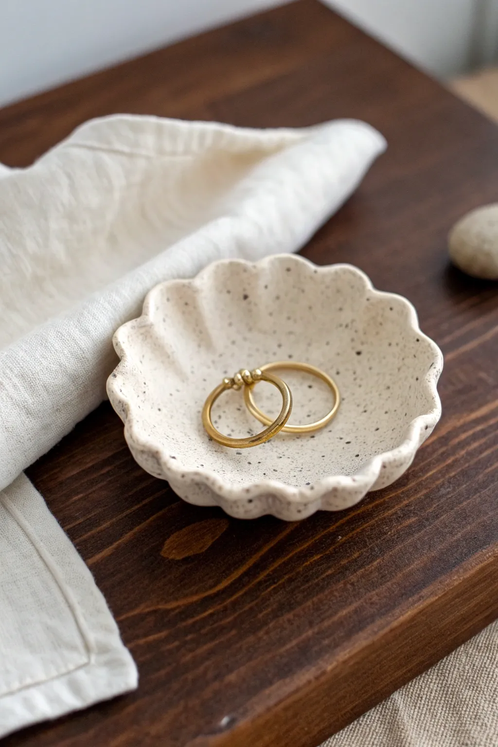 Mini air dry clay trinket dish with scalloped rim and ring cone, simple boho elegance.