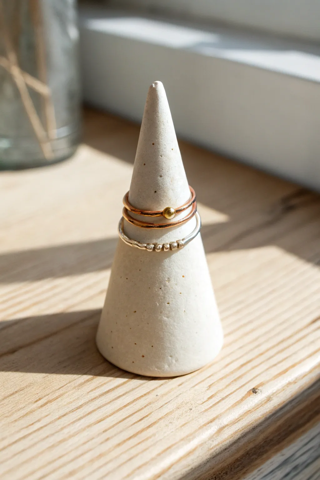 A cute minimalist cone ring holder with subtle hand-painted dots, perfect for everyday rings.