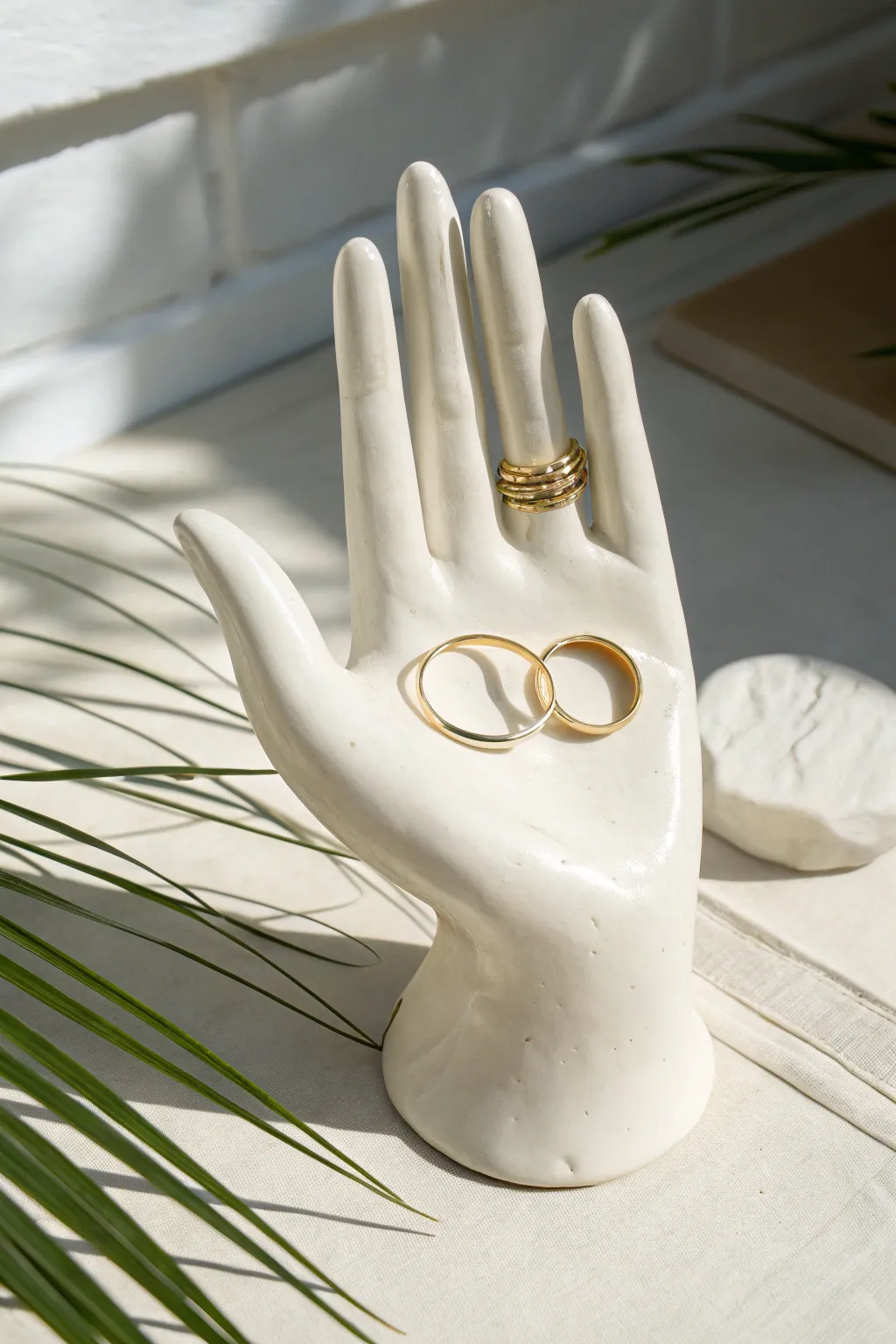 Minimal hand-shaped clay ring holder with two simple rings, styled in airy Scandinavian calm