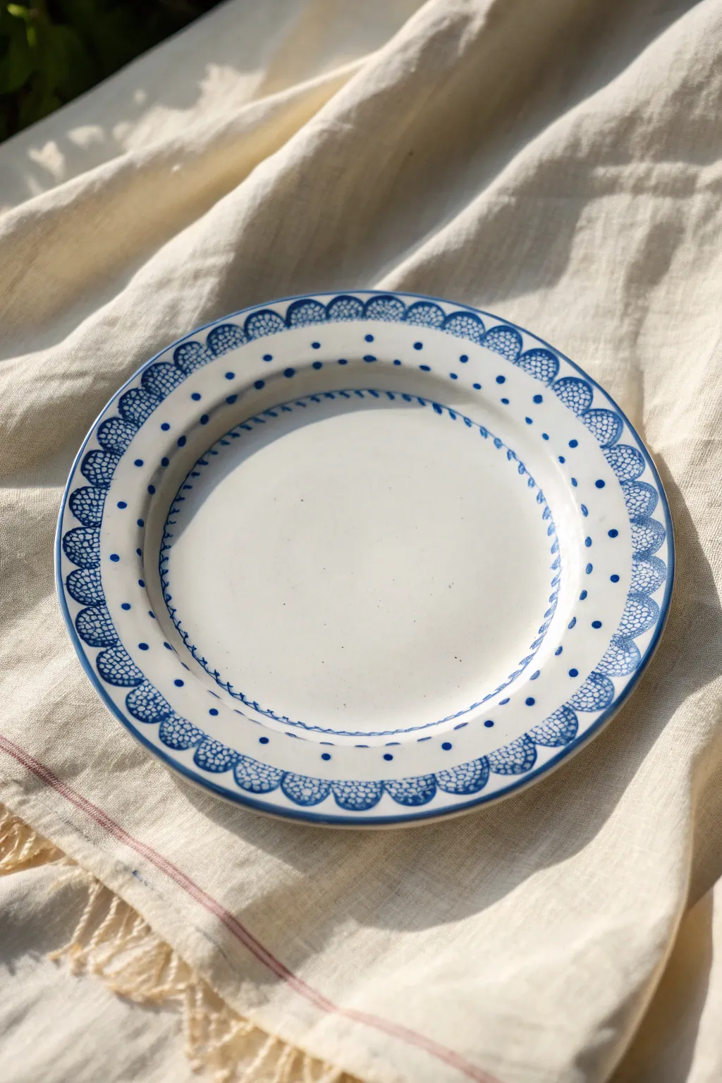 Minimal blue-and-white rim pattern with scallops and dots for an easy, timeless plate design