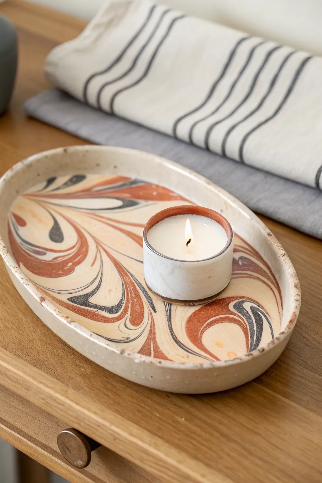 Bold marbled swirl clay tray, simply styled with one candle for calm minimalist charm
