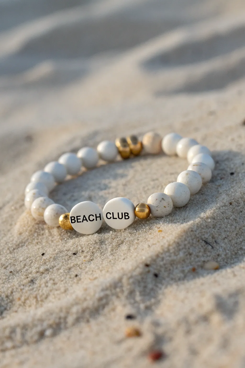 Classic beach-club monogram clay bead bracelet with white beads and gold spacers, minimalist chic