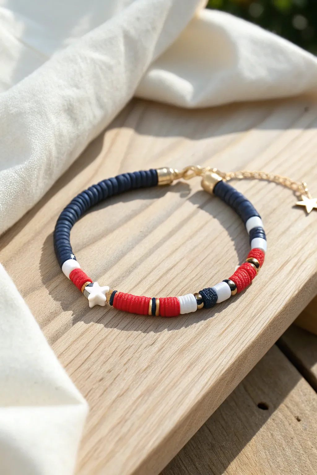 Star-spaced heishi bracelet in navy, red, white, and sky blue for sporty preppy charm.