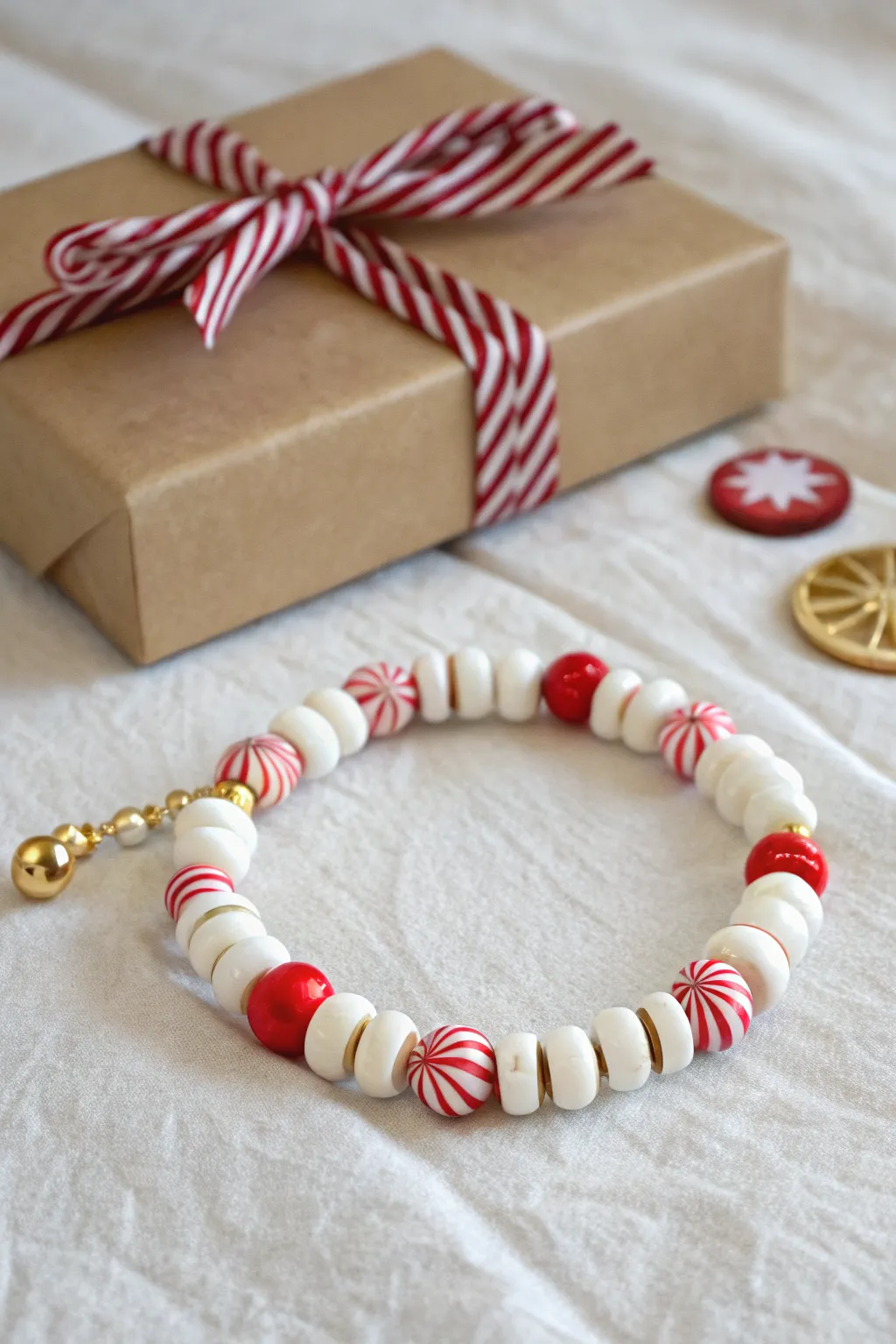 Preppy peppermint swirl focal beads elevate a white heishi bracelet for a chic holiday gift vibe.
