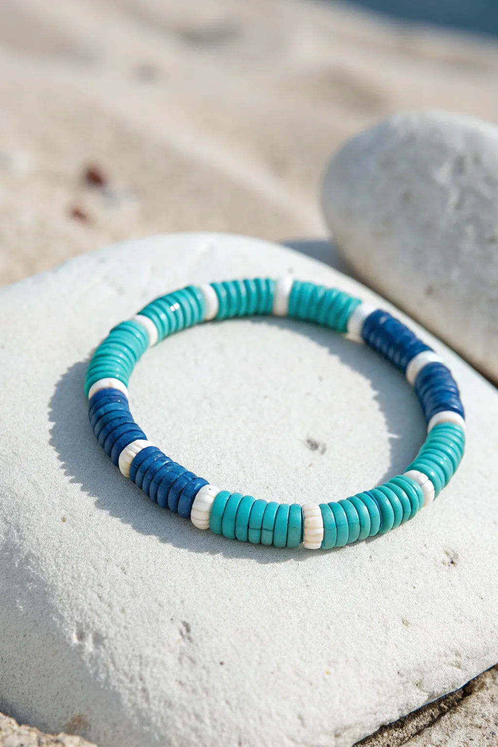 Surf-inspired blue heishi bracelet in aqua, teal, and cobalt with crisp white accents.