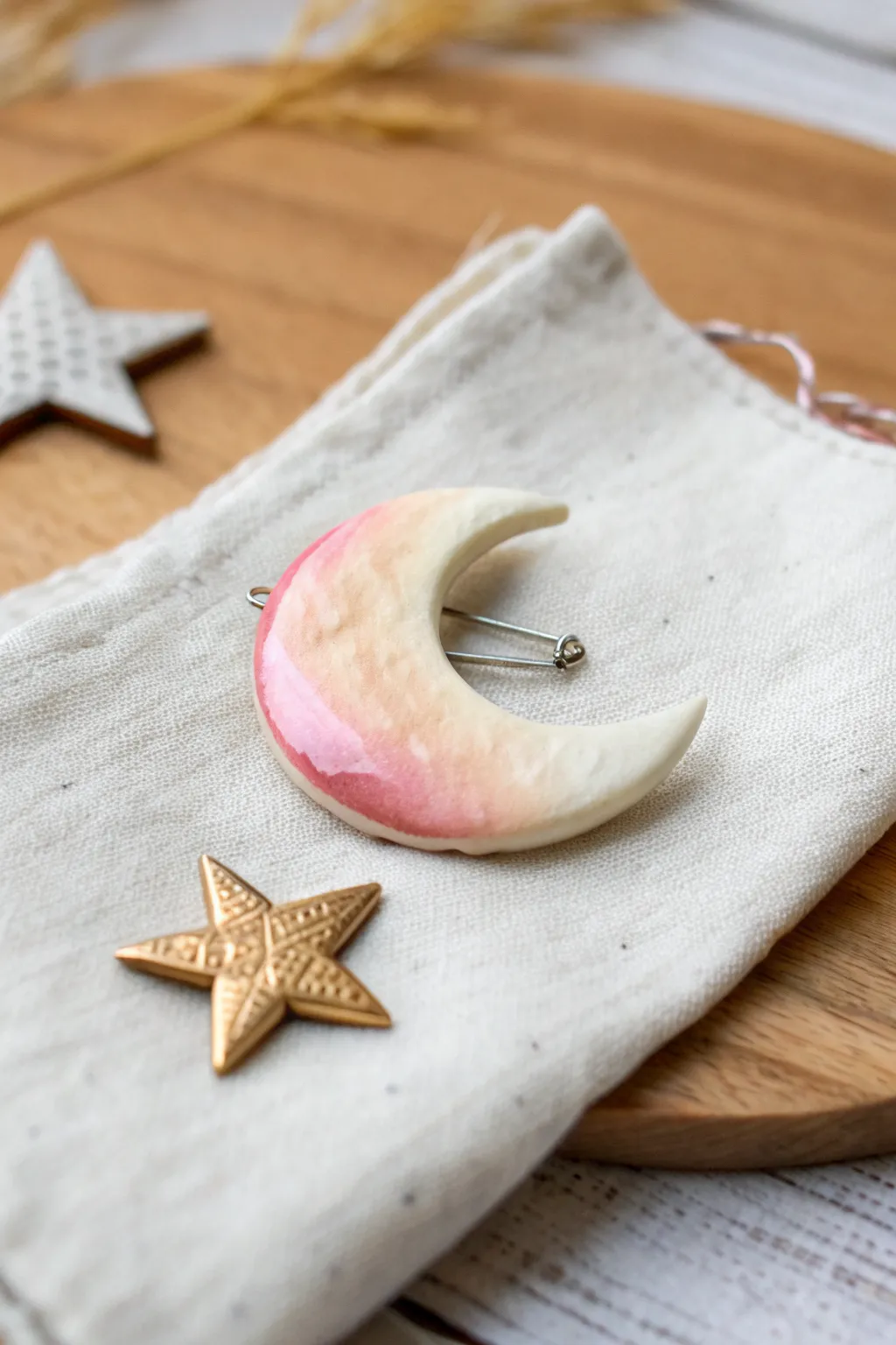 A dreamy puffy clay moon pin in soft pastels, minimalist yet boho, perfect for everyday charm.