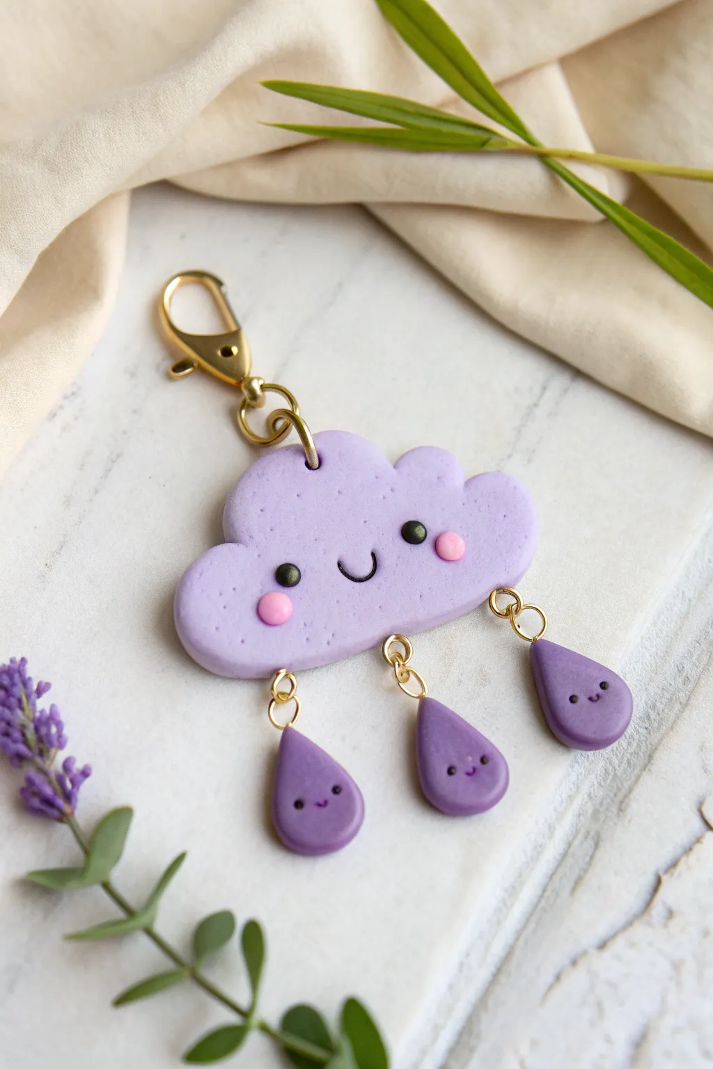 Purple cloud and lavender raindrop charms that add a soft, dreamy touch to any keychain