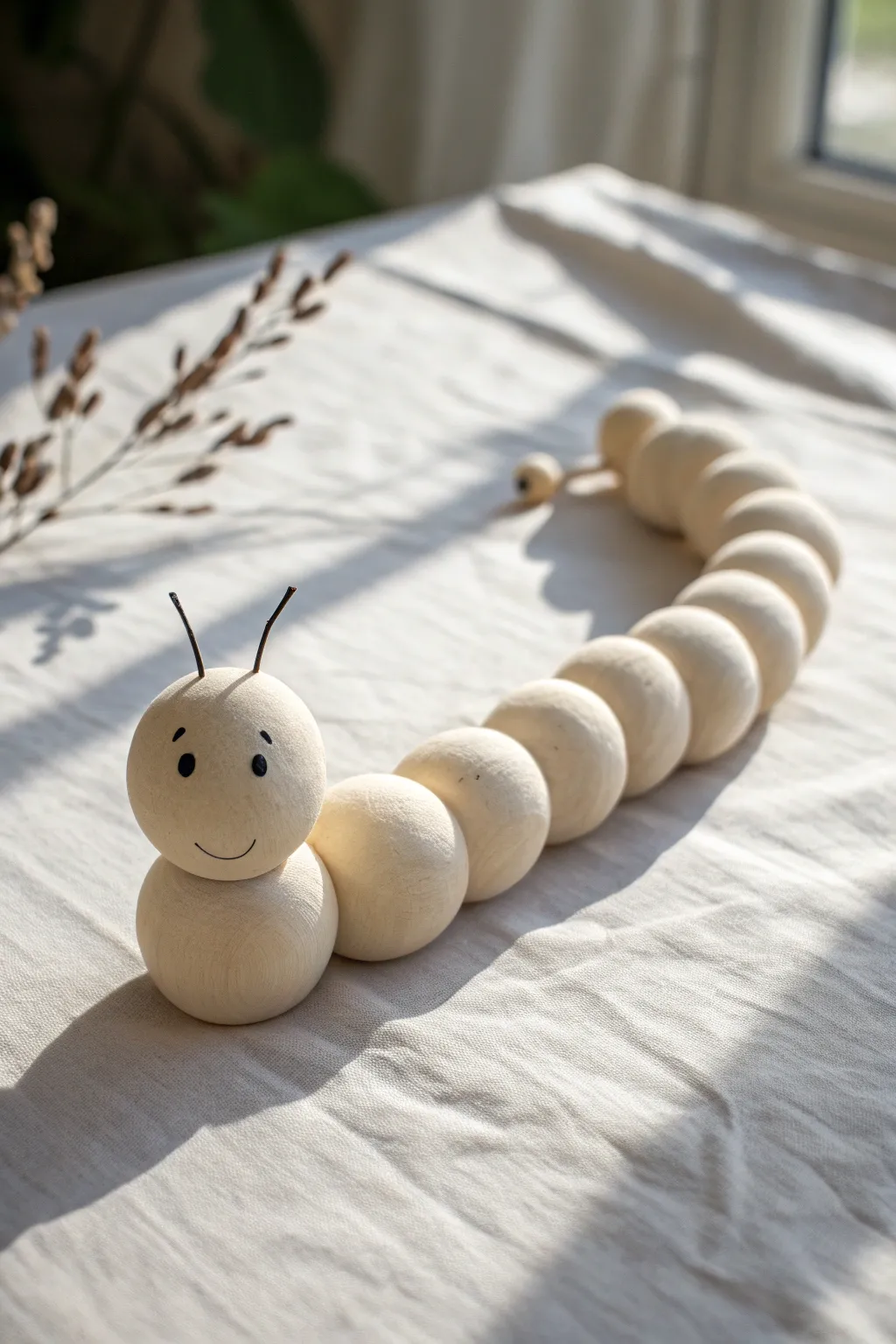 Minimal clay ball caterpillar with sweet dot eyes, easy handmade charm for your next project.