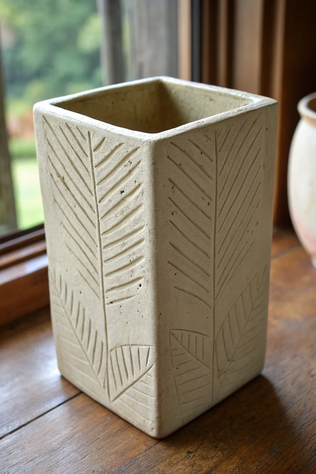 Boxy slab vessel with a carved panel and clean sgraffito lines for simple modern texture.