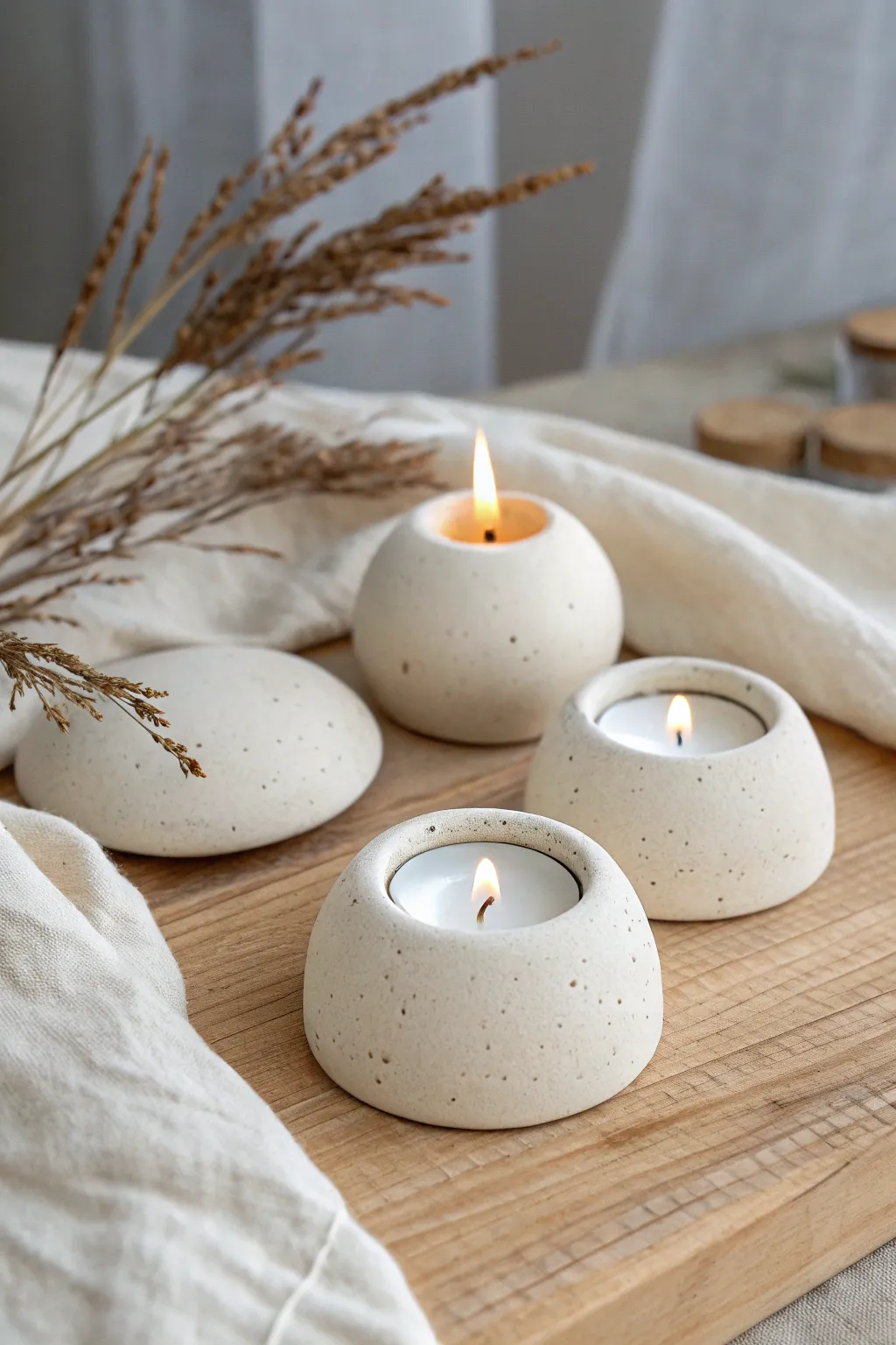 Three tiny clay tea light holders in simple shapes for a cozy, minimalist Scandinavian feel