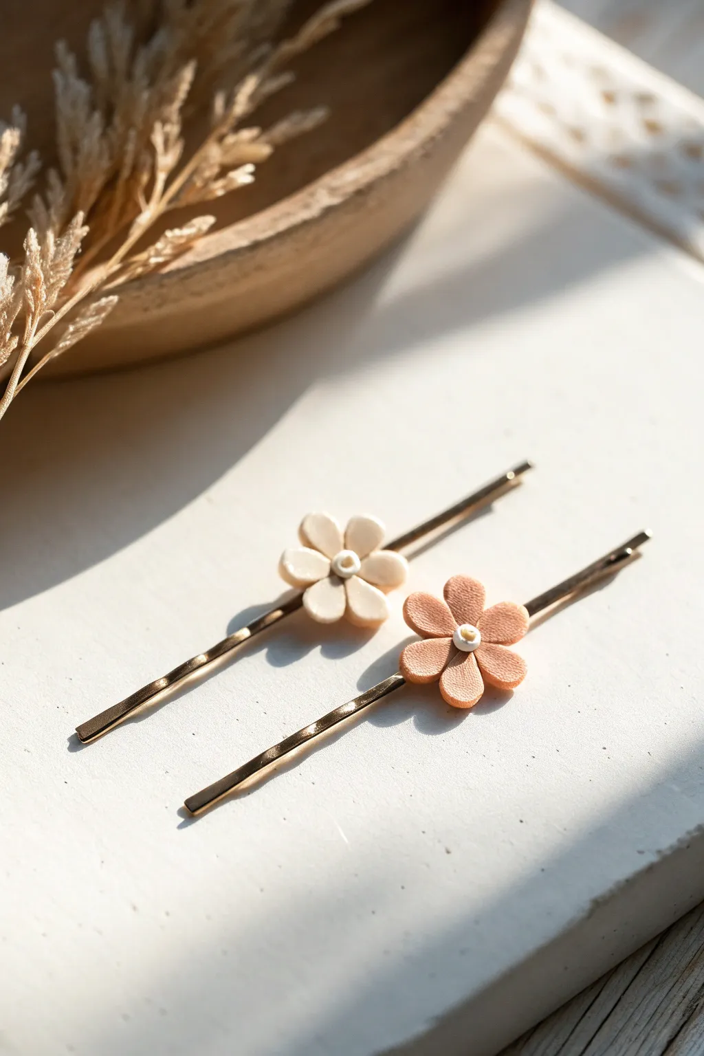 Tiny polymer clay bow and flower hair pin toppers in soft blush tones, clean and minimal