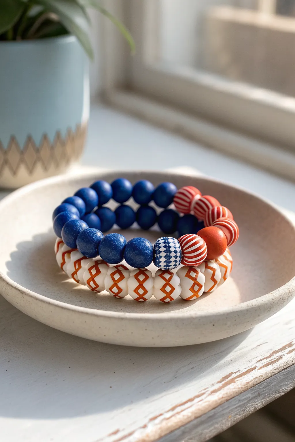 Bold blue stitch accents meet sunny red orange clay beads for a clean Scandinavian boho stack