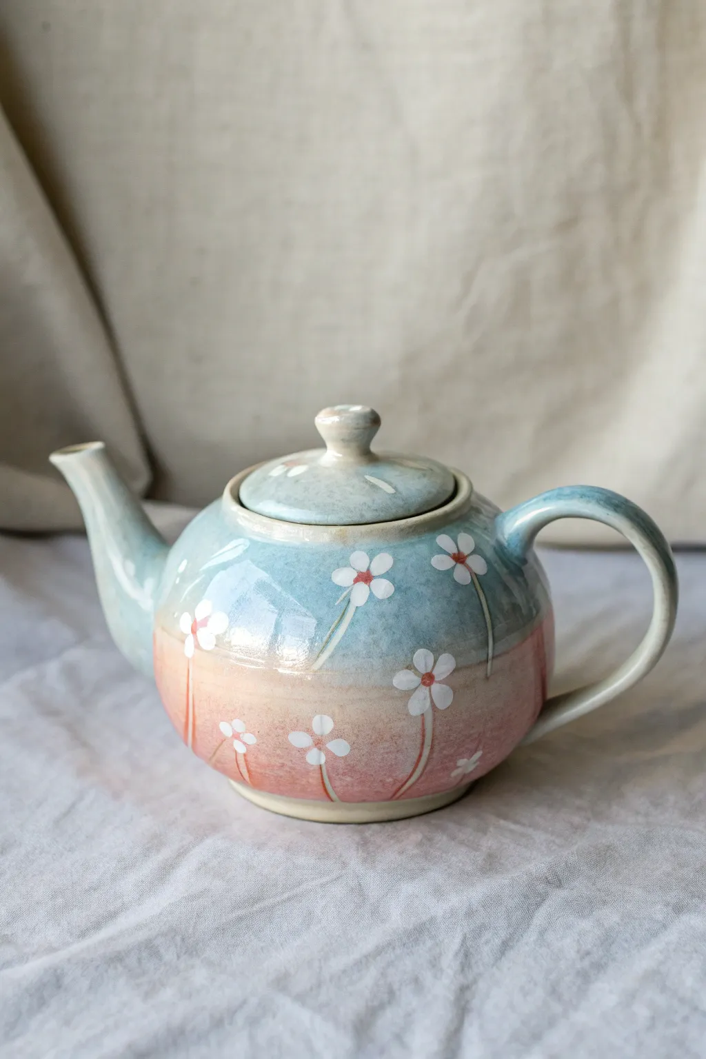 Dreamy teapot painting idea: soft watercolor wash blend with simple white floral silhouettes