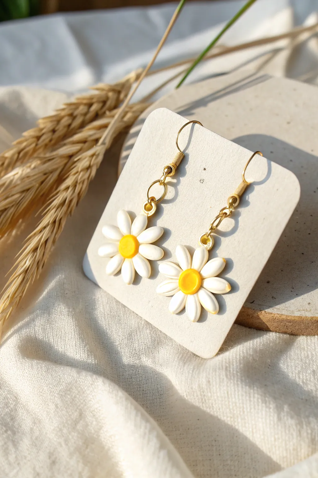 Sweet daisy dangle earrings with bright yellow centers, perfect for an easy everyday pop.
