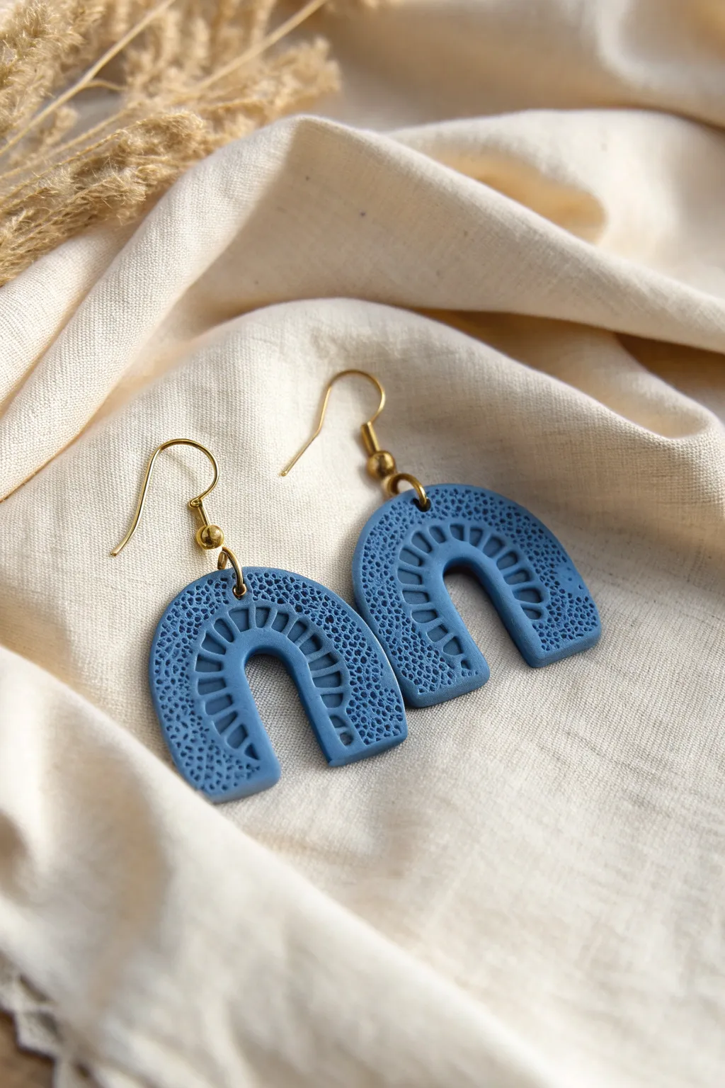 Pressed lace air dry clay earrings in bold blue, minimalist styling that lets texture shine.