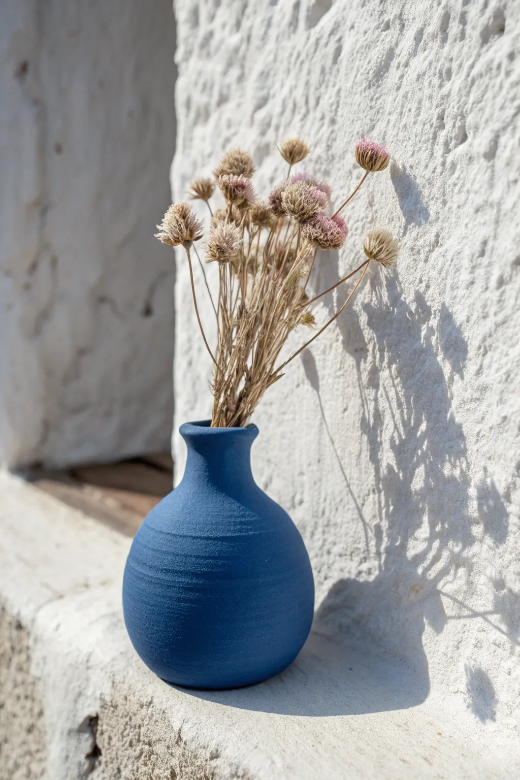 DIY tiny air dry clay magnet vase with a single dried bloom, minimalist and boho wall decor