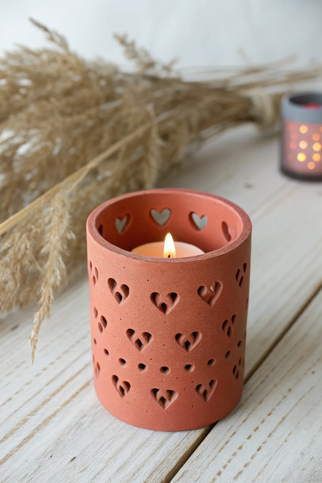Air-dry clay tea light holder with glowing heart cutouts, a cozy handmade Mothers Day gift.