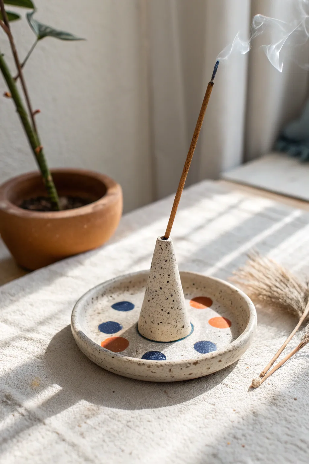 Minimal carved air-dry clay incense holder with painted dots for a calm, modern nook