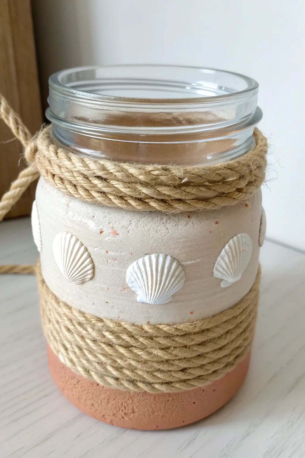 Sand-beige clay wrapped jar with a simple jute rope band for an easy coastal boho look