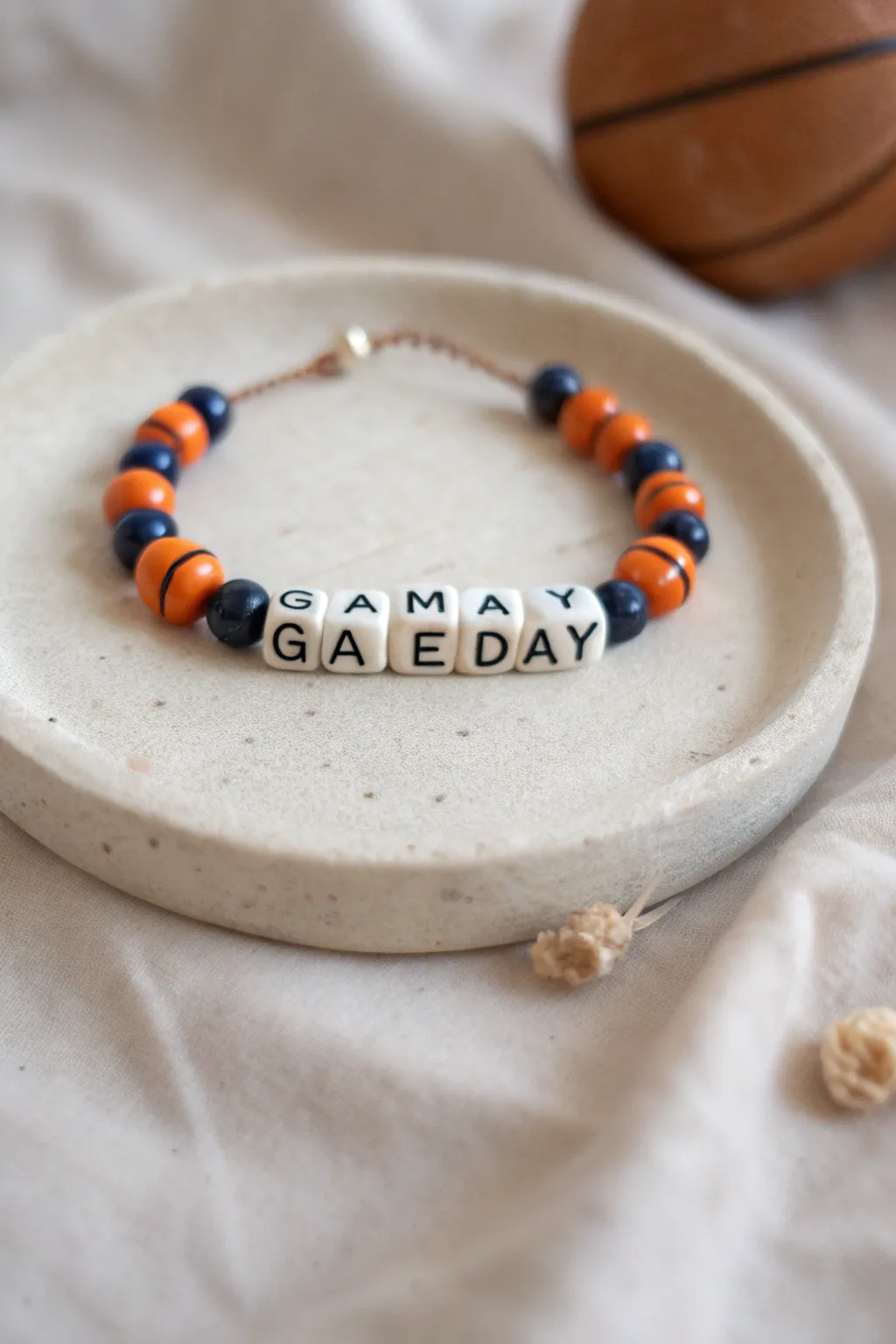 Minimalist Game Day bracelet with bold team colors and a tiny basketball charm, ready for tipoff